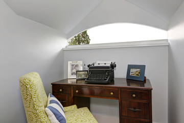 Small home office area with retro typing machine.