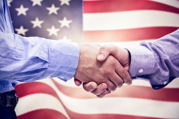 Composite image of two men shaking hands