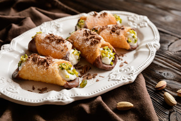 Traditional Sicilian cannoli stuffed with ricotta and pistachios