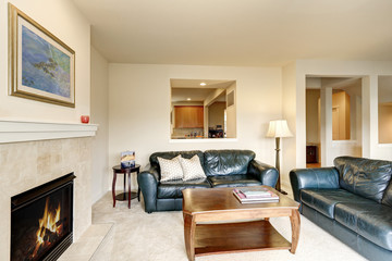 Family room with green leather sofas and wooden cocktail table