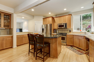 Bright wooden kitchen room with stainless steel appliances