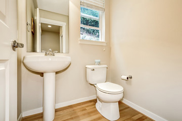 View of washbasin stand and toilet in half bathroom