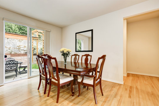 Light dining room with wooden carved table and chair set