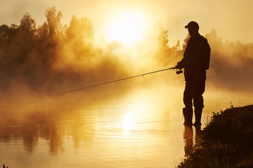 fisher fishing on foggy sunrise - Powered by Adobe