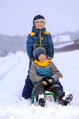 Fototapeta na wymiar happy boys on sled