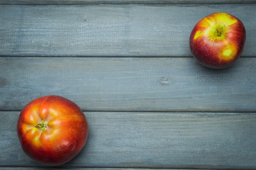 Whole green red ripe apples autumn harvest from above on dark gray blue wooden table