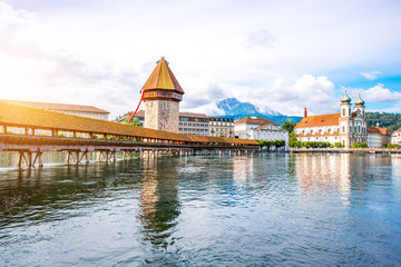 Cityscape view on the famous wooden bridge and tower on Reuss river in Lucerne old town in...