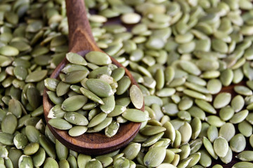 Pumpkin seeds in a wooden spoon
