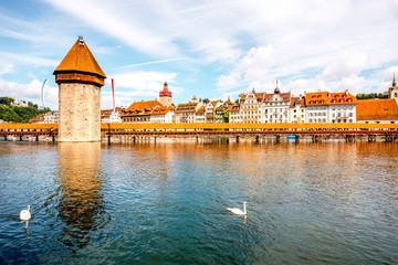 Cityscape view on the famous wooden bridge with tower on Reuss river in Lucerne old town in Switzerland
