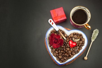 Romantic coffee. Marriage proposal. Coffee beans and a gold ring. Breakfast for lovers. Declaration of love on Valentine's Day.
