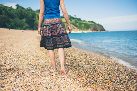 Young woman walking on the beach