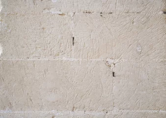 Crédence de cuisine en verre imprimé Pierres Traditional white stone wall. Detail of a wall made of white limestone bricks. Visible traces of chisel.