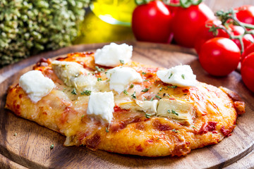 pizza with artichoke and oregan on wood
