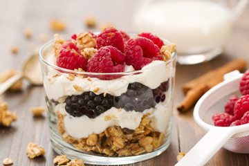 granola with cheese and berries in cup