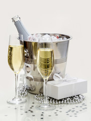 Two champagne glasses, cooler