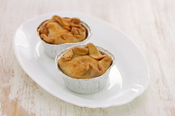 portuguese chicken cookies on white dish on wooden background