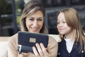 Mother and daughter playing with makeup.