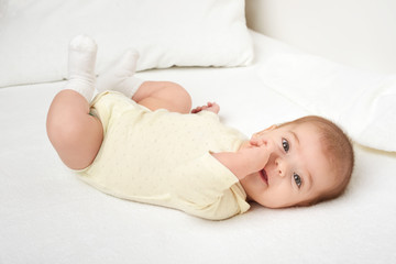 baby portrait lie on white towel in bed