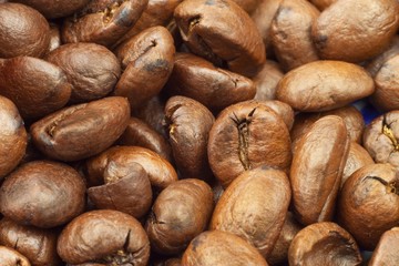 Details of Roasted coffee beans. Close up shot of a pile of roasted coffee beans
