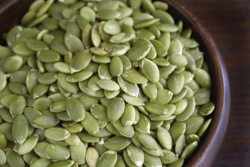 Pumpkin seeds in a wooden bowl