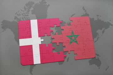 puzzle with the national flag of denmark and morocco on a world map background.