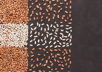 Brown and white beans on a wooden background, horizontal, soft focus