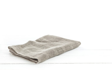 Fototapeta na wymiar Folded Burlap hessian or sacking tablecloth on white wooden background for product montage