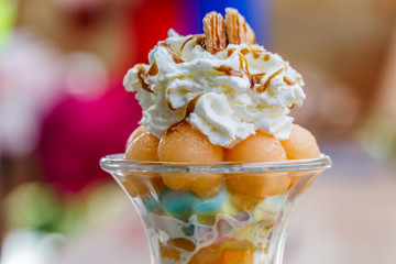 Fresh fruit salad with ice cream in a  melon cup