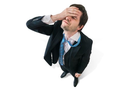 Businessman has headache. Disappointment and failure concept. Isolated on white background.