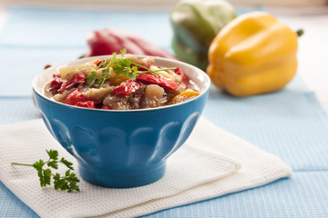 Colorful vegetable stew in a blue bowl