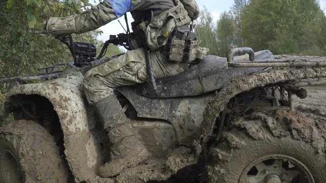 Military ATV with a gun in the mud