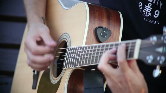 Guitarist Playing on Acoustic Guitar on Street