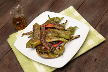 fried peppers in olive oil on dish
