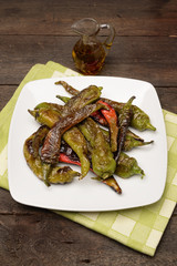 fried peppers in olive oil on dish
