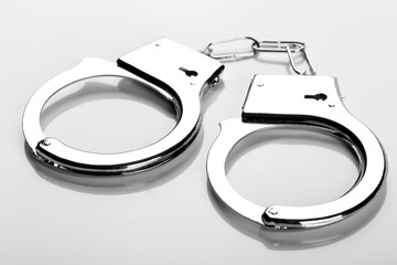Pair of handcuffs on white
