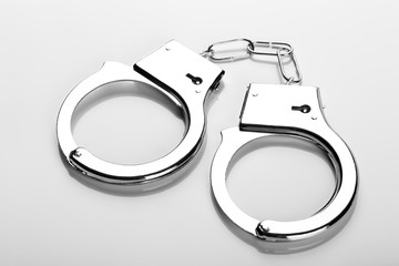 Pair of handcuffs on white