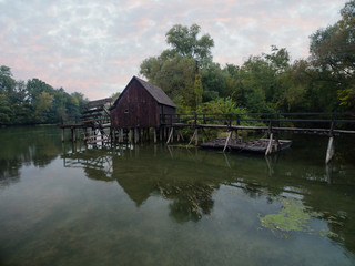 Fototapeta na wymiar Old watermill on Small Danube near the village Tomasikovo, Slovakia at dusk