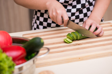Young woman housewife working in the kitchen