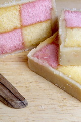 Freshly cut Battenberg Cake with knife. Pink and yellow sponge covered in marzipan