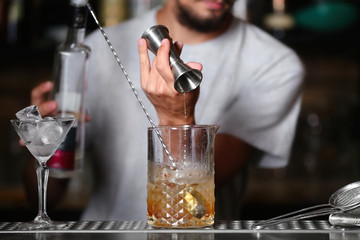 Barman preparing cocktail on bar counter