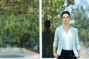 Beautiful businesswoman on window background