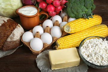 Vegetables and dairy products on wooden background