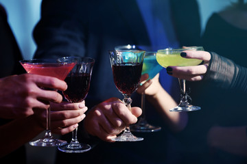 People drinking cocktails at Halloween party, close up