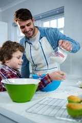 Father and son preparing cupcake