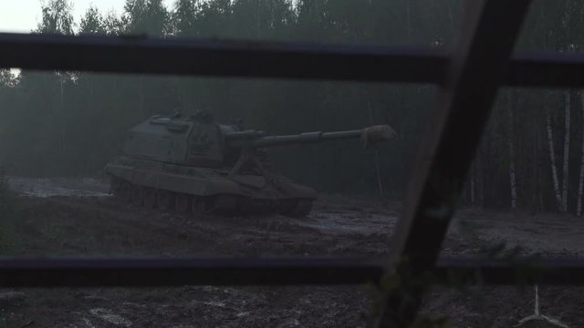 Self-propelled artillery unit on the road in a forest