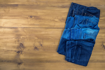 Blue jeans on a brown wooden background and Blue jeans denim Col