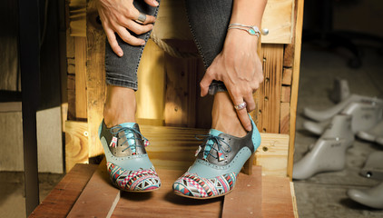 Closeup on woman legs with fashionable, hand crafted, custom made high heels