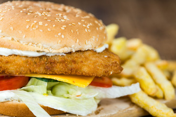 Wooden table with a fresh made Fish Burger