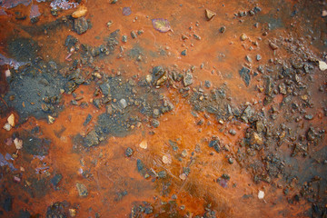 Orange precipitate on the banks of the river closeup