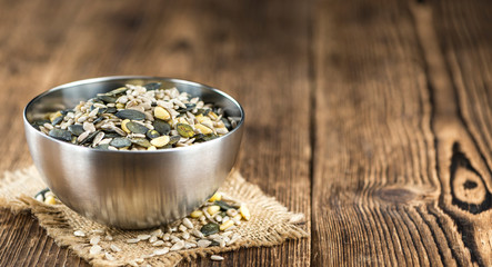 Old wooden table with mixed Seeds (selective focus)